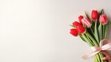 Fototapeta Tulipany - Women's hands holding a bouquet of red tulips for congratulations on Mother's Day, Valentine's Day, women's Day. Blurred background.