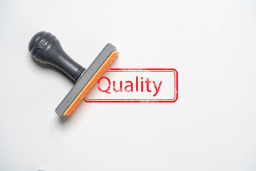 Fototapete - Rubber stamping red quality wording on white paper for product and service guarantee concept.