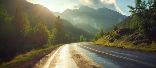 Blurry image of mountain road with sunlight patches.