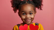 Little beautiful girl holding a heart shaped paper, Valentines day child theme