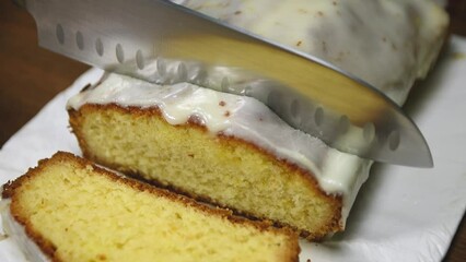 Wall Mural - Woman cutting a orange cake on wooden table in the kitchen, close up