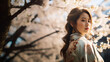 Amidst a bloom of cherry blossoms, a woman in a traditional outfit reflects the beauty and elegance of hanami season