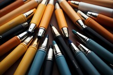 Aerial Perspective Of A Diverse Array Of School Pens On A Light Orange Surface