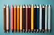 A neatly arranged set of school notebooks, pens, and pencils seen from a top view on a soft pastel background