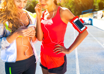 runners on the stadium track. women summer fitness workout