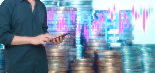 businessman using smartphone with blurred coins and trading graph background inconcept of investment and financial fund