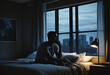 Depressed man losing his job and heartbroken sitting alone in bed near a window in dark with the low light environment, PTSD Mental health, and depression concept.psychological problem, sadness