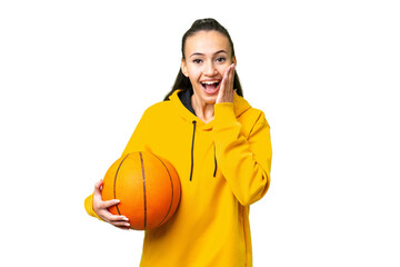 Wall Mural - Young Arabian woman playing basketball over isolated wall  over isolated chroma key background with surprise and shocked facial expression