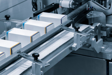 Poster - Automatic packaging conveyor line in pharmaceutical factory, pharmaceutical industrial concept background
