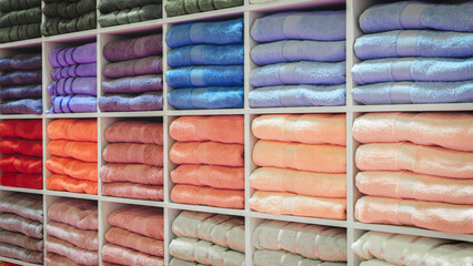 Leinwandbilder - Multi-colored towels on a shelf in a store