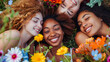 A group selfie of four happy young women, surrounded by a colorful array of spring flowers, embodying the spirit of youth and friendship