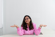 © Thales - Portrait of a psychopedagogue, wearing pink clothes, in her office, sitting, making a sign with her hand. Helps with school performance.