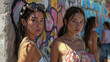 © Faith Stock - Portrait of two young girls on the background of graffiti wall.