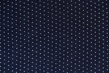 Abstract Background Of Dark Blue And White Polka Dot Knit Fabric Texture Close Up
