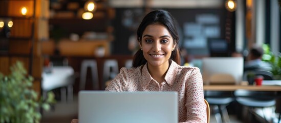 Wall Mural - happy and accomplished female indian programmer working in a contemporary office, providing tech sup