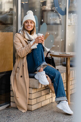 Wall Mural - stylish woman walking in winter street