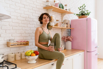 Wall Mural - healthy slim woman in kitchen in the morning, diet food wellness