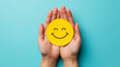 © Soekahurip - hands holding happy smile face for medical concept, mental healt positive thingking