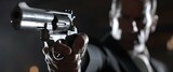 Fototapeta  - pointing a gun at the target on dark background, selective focus on front gun