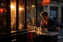 A Man Sitting Outside A Cafe In Paris Drinking Coffee And Tee On A Beautiful Evening. Ai Generated