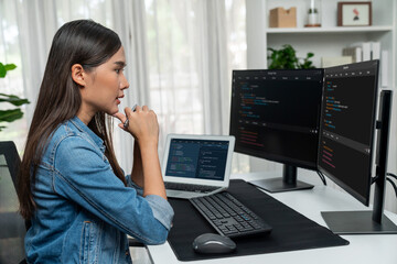 young asian it developer looking online information on pc for beautiful pose with coding program dat