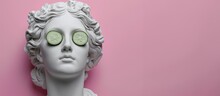 Face Sculpture Of Aphrodite With Sliced Cucumber Slices Over Her Eyes On A Pink Background.