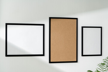 Canvas Print - Blank picture frames on the white wall copy space