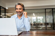 © Stock 4 You - Happy senior latin Hispanic man in wearing headphones, helping as callcenter consult assistant. Smiling mature 40s years old mixed race businessman holding video call with clients partners. Copy space