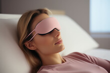 Woman Resting With A Pink Eye Mask In A Bright Room.