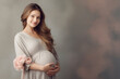 © MAKSIM MAKSIMOV - Pregnant woman smiling, simple background with copy space