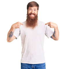 Sticker - Handsome young red head man with long beard wearing casual white tshirt looking confident with smile on face, pointing oneself with fingers proud and happy.