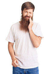 Wall Mural - Handsome young red head man with long beard wearing casual white tshirt touching mouth with hand with painful expression because of toothache or dental illness on teeth. dentist