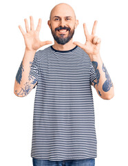 Sticker - Young handsome man wearing casual clothes showing and pointing up with fingers number eight while smiling confident and happy.