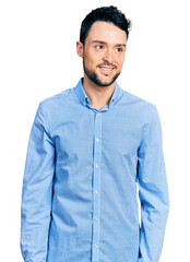 Poster - Hispanic man with beard wearing casual business shirt looking away to side with smile on face, natural expression. laughing confident.