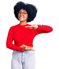 Poster - Young african american girl wearing casual clothes and glasses gesturing with hands showing big and large size sign, measure symbol. smiling looking at the camera. measuring concept.