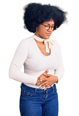 Sticker - Young african american girl wearing casual clothes and glasses with hand on stomach because indigestion, painful illness feeling unwell. ache concept.