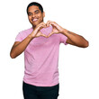 © Krakenimages.com - Young handsome hispanic man wearing casual pink t shirt smiling in love showing heart symbol and shape with hands. romantic concept.