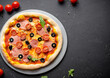 © Gustav - pizza on a plate black table background