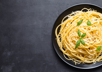 spaghetti on a plate black table background