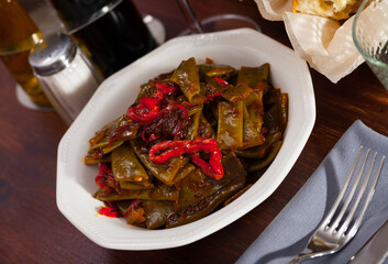 Wall Mural - Delicious stewed green beans with red bell pepper. Vegetarian concept..