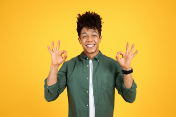 Wall Mural - Positive young black guy showing okay gesture