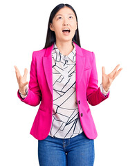 Poster - Young beautiful chinese woman wearing elegant clothes crazy and mad shouting and yelling with aggressive expression and arms raised. frustration concept.