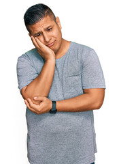 Sticker - Young latin man wearing casual clothes thinking looking tired and bored with depression problems with crossed arms.