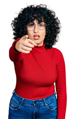 Canvas Print - Young middle east girl wearing casual clothes and glasses pointing displeased and frustrated to the camera, angry and furious with you