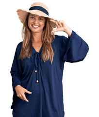 Poster - Middle age hispanic woman wearing summer hat smiling and confident gesturing with hand doing small size sign with fingers looking and the camera. measure concept.