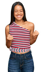 Sticker - Beautiful hispanic woman wearing casual clothes excited for success with arms raised and eyes closed celebrating victory smiling. winner concept.