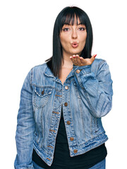 Canvas Print - Young hispanic woman wearing casual clothes looking at the camera blowing a kiss with hand on air being lovely and sexy. love expression.