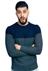 Wall Mural - Young arab man with beard with arms crossed gesture afraid and shocked with surprise and amazed expression, fear and excited face.