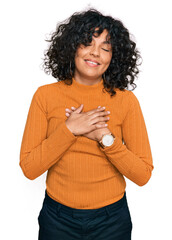 Poster - Young hispanic woman wearing casual clothes smiling with hands on chest with closed eyes and grateful gesture on face. health concept.