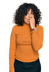 Poster - Young hispanic woman wearing casual clothes looking stressed and nervous with hands on mouth biting nails. anxiety problem.